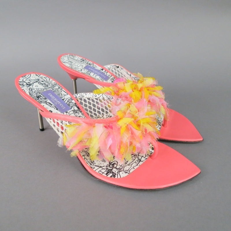 Gorgeous spring sandals by EMILIO PUCCI. A fun style in coral leather, featuring a thick thong strap in white fishnet embellished with printed frayed fabric fringe, comic print sole, and a skinny metal heel. Made in Italy.
 
Excellent Pre-Owned
