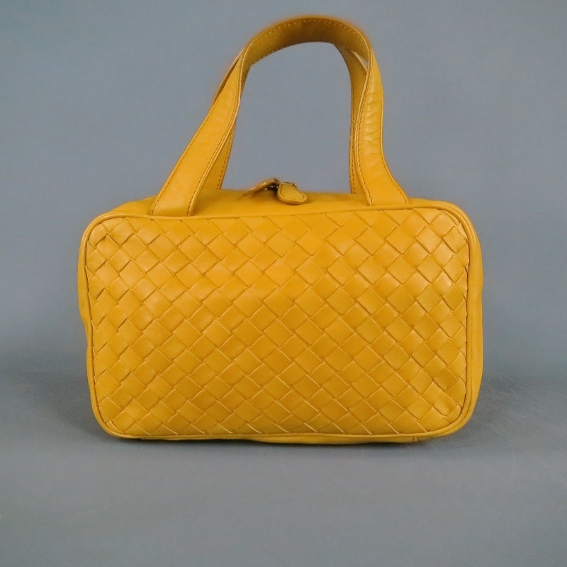 Cute mini handbag by BOTTEGA VENETA. A small rectangular zip style woven in  signature Intrecciato canary yellow leather featuring cosmetic storage pockets inside perfect for makeup brushes. A very unique piece in a fabulous color great gift for a