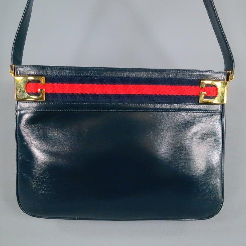 Gorgeous vintage shoulder bag by GUCCI. A classic style with modern appeal from the 1960's in fabulous condition. IN navy leather with gold 