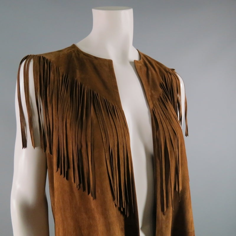 Get festive in this stunning tan goat suede fringe vest for COLLECTION by Ralph Lauren.  Long silhouette with fringe at shoulders and high-low base.  No closures at center front- meant to be worn open and free!  Made in Italy.
 
 
Excellent Pre-