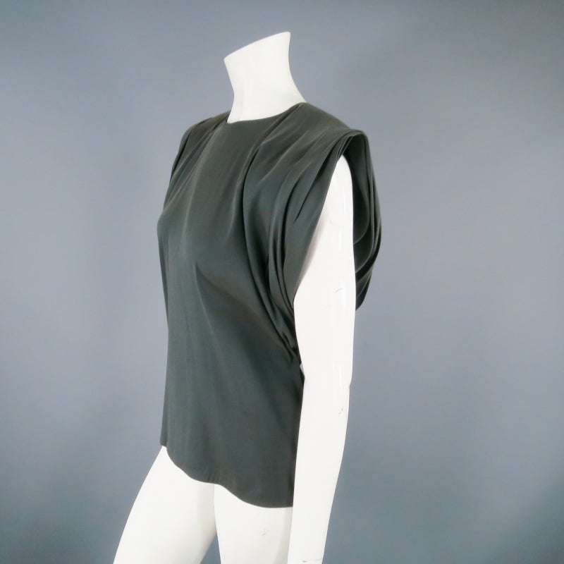 Dramatic shoulder blouse by LANVIN. A gorgeous archive piece from 2012, featuring a high neck and boxy cut with with strong shoulders constructed with layers pleated fabric. An elegant, understated style with high impact appeal. Made in