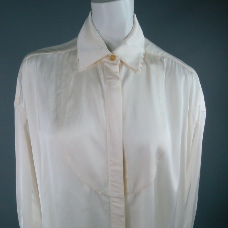 Gorgeous cream satin collared blouse by LANVIN Ete 2006. A unique over sized style with A-line silhouette featuring a hidden placket, bib detail, and optional matching ribbon to tie around the neck. A classic piece with timeless appeal. Made in