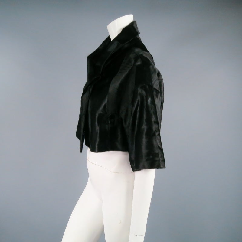 Gorgeous cropped leather jacket by MARNI. Not your typical bolero, this piece comes in short Xiangao lamb fur trimmed to create a soft velvet like texture an features an elegant silhouette with 3/4 sleeves and wrap collar with hook eye closure.