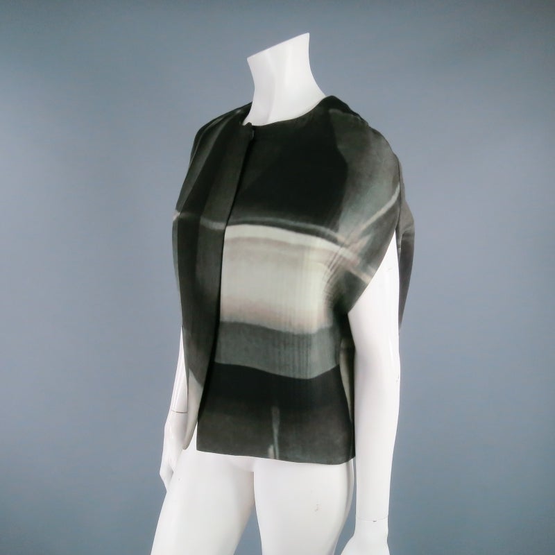 Fabulous printed capelet vest by MARNI. A structured, shell silhouette piece in an abstract photo print featuring a high neck line and hidden placket snap closure. Very 1960's mod for the 21st Century. Made in Italy.

Excellent Pre-Owned