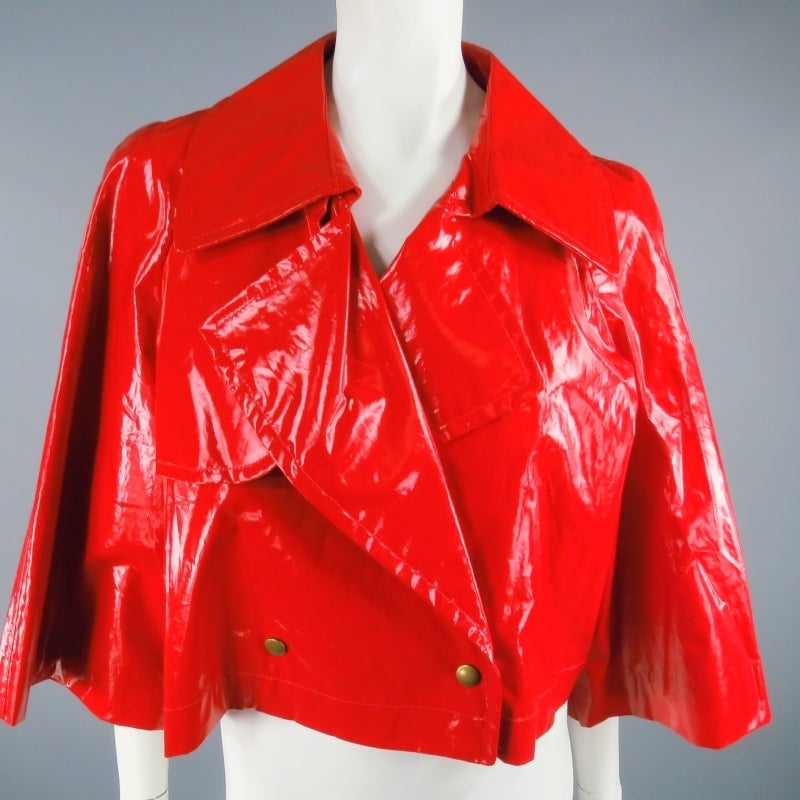 Fabulous cropped raincoat jacket by LANVIN Ete 2007. In a vibrant high gloss red, this unique piece features a 3/4 sleeve, double breasted snap closure, and classic trench coat lapel details. Made in France.

Excellent Pre-owned