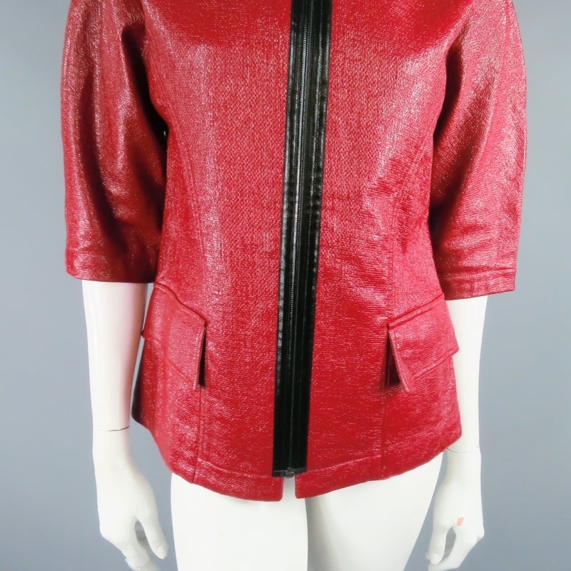 Fabulous textured sport jacket by LONGCHAMP. This retro silhouette style comes in burgundy high gloss coated fabric with beautiful texture and features a boat neck, front pockets, 3/4 sleeve, and exposed black zipper closure. A 1960's mod inspired