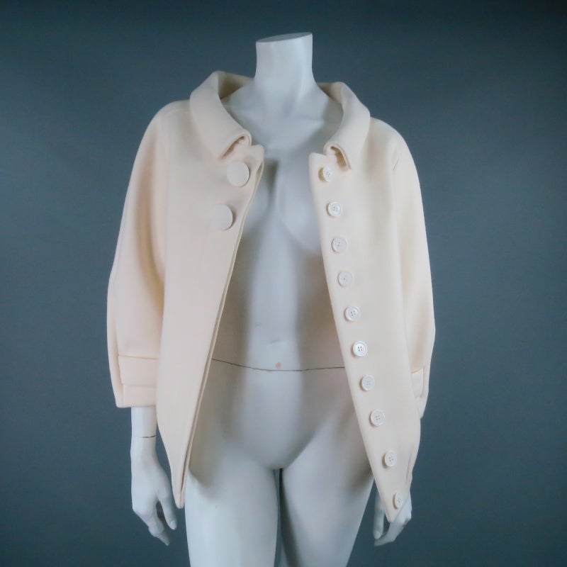Gorgeous cream wool jacket from BALENCIAGA by Nicolas Ghesquière. A rare piece from the fall 2006 collection, this structured style draws influence from classic 1960's Cristóbal Balenciaga silhouettes with a modern, minimalist flair. Featuring a