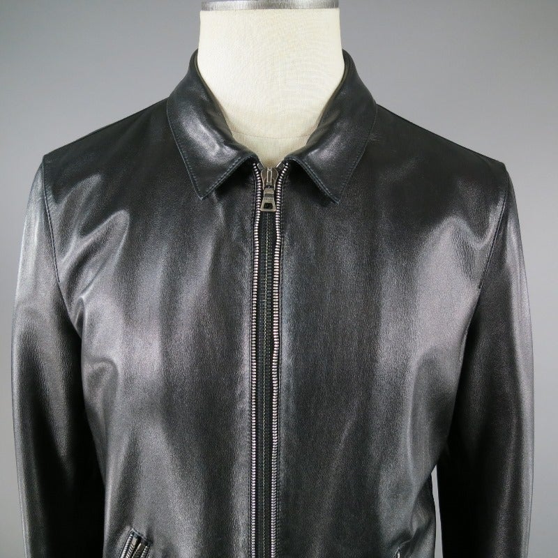 This Prada Black Leather Jacket is classic and sleek.  Piece features double zipper detailing at center front, pockets and sleeves.  Made in Italy.
 
Excellent Pre Owned Condition.
Tag Size: IT 50
 
Measurements:
Shoulder: 18 in.
Chest: 40