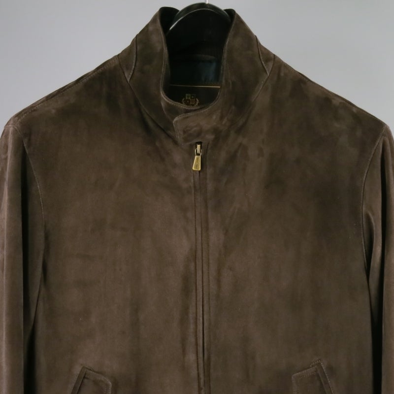 Gorgeous kidskin (young goat) suede biker jacket by LORO PIANA. A high collar zip closure style in a rich chocolate brown featuring frontal snap pockets, waist band with tabs, and silk blend lining with internal storage pockets. Light weight and