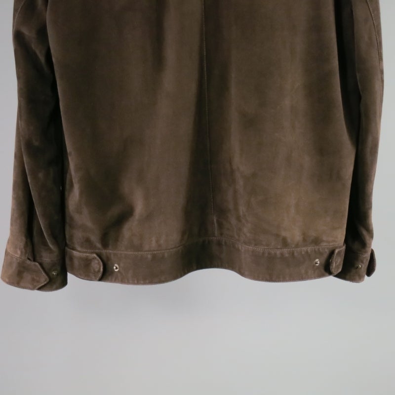 Classic brown leather jacket by Loro Piana. A collared worker style with double zip closure featuring tarnished gold hardware, tortoise logo buttons on sleeves and back tabs, side slit pockets, detachable zip off collar and tan cashmere lining with