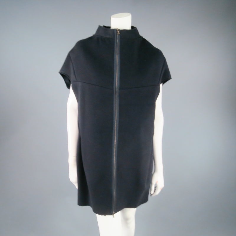 Sleeveless coat dress by MARNI. A unique style in raw edge navy wool featuring a high neck, structured shell silhouette, and gold zip closure. Great for Fall/Winter layering for worn as a dress. Made in Italy.
 
Excellent Pre-Owned Condition.
