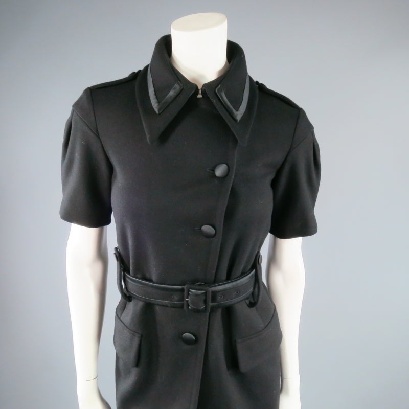 Short Sleeve structured wool coat by MIU MIU. A classic piece with modern details, this piece features a layered collar with satin piping, five button closure, pleated puff sleeve with epaulette shoulder, flap pockets, and satin trimmed waist belt.