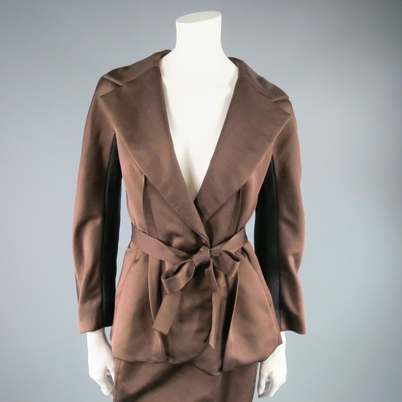 Gorgeous copper satin skirt set by LANVIN. On top, a tailored jacket with notch lapel featuring black arm panels and dart details and a gathered pleat skirt with elastic waist on bottom. Fabulous together or separate. Made in France.
 
Excellent