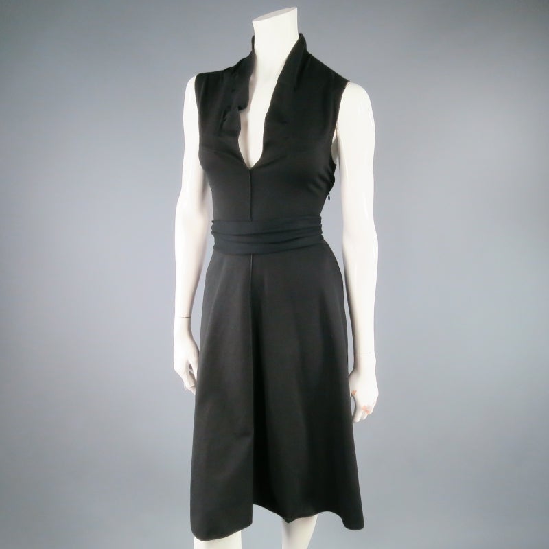 Lovely stretch nylon sheath dress by YVES SAINT LAURENT. A classic everyday sleeveless style featuring darted ruffle V neck, external stitch details, A-line skirt, and sash belt to tie at the waist.  Made in Italy.
 
Excellent Pre-Owned