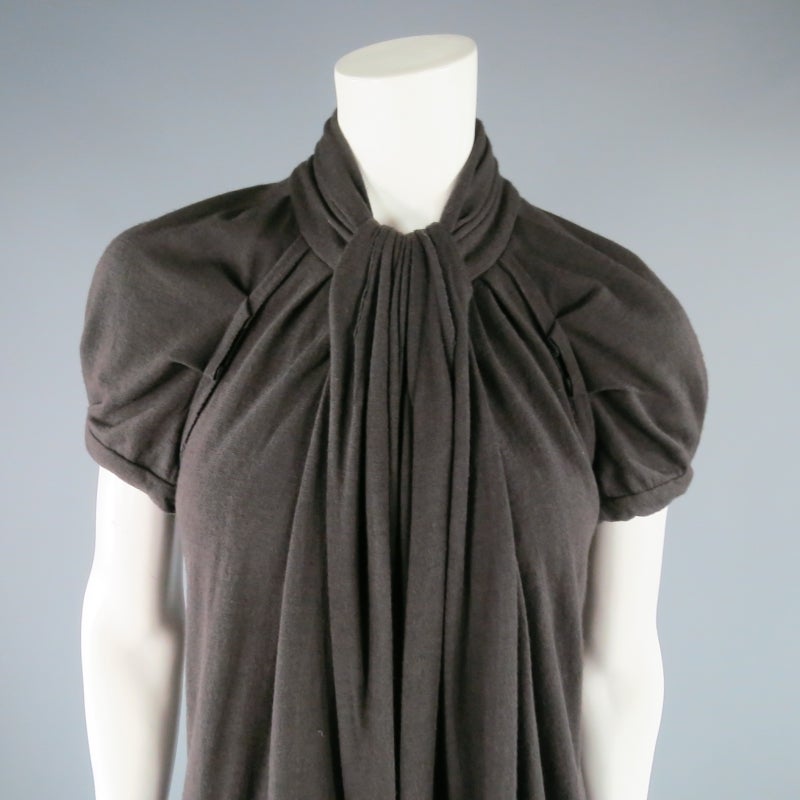 Lovely fall dress by MARC JACOBS. In a deep taupe brown stretch wool, this style features short puff sleeves, A-line silhouette, and mock neck with draped sash detail. Perfect for cool weather. Made in USA.
 
Excellent Pre-Owned Condition.
