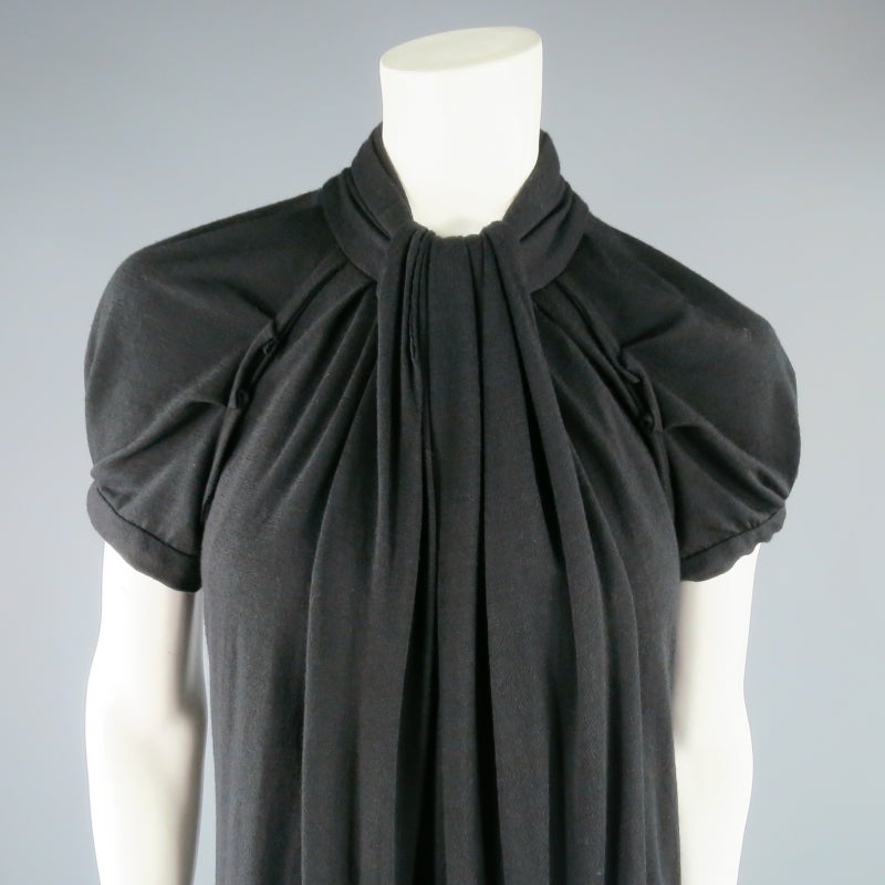 Lovely fall dress by MARC JACOBS. In a black stretch wool, this style features short puff sleeves, A-line silhouette, and mock neck with draped sash detail. Perfect for cool weather. Made in USA.
 
Excellent Pre-Owned Condition.
