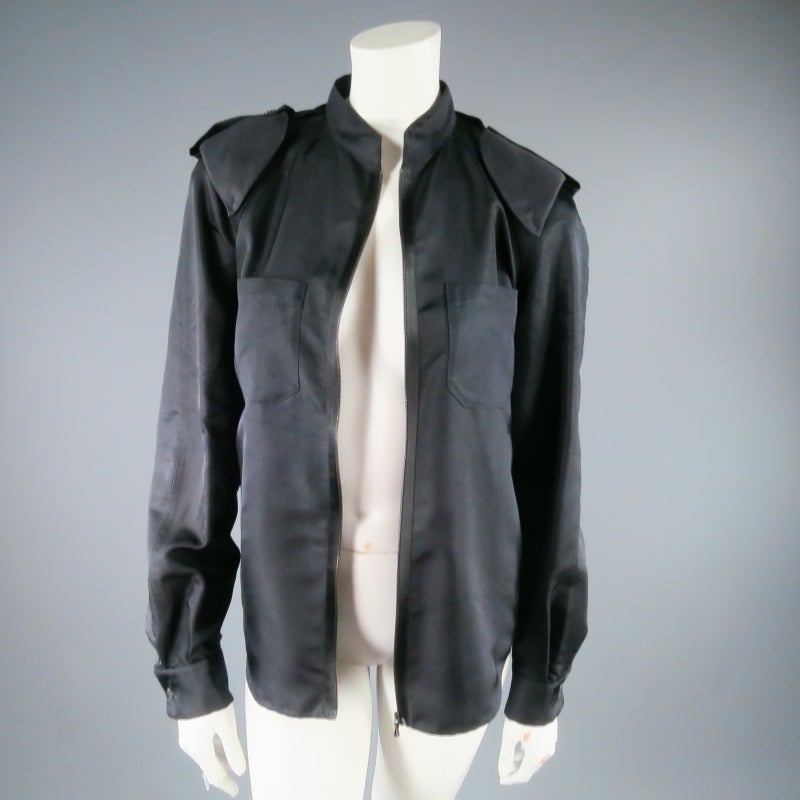 Gorgeous black silk jacket by LANVIN. A utility style in luxury material, this piece features a band collar, external shoulder pads with epaulette detail, breast patch pockets, back pleats, and zip closure. Made in France.
 
Excellent Pre-Owned