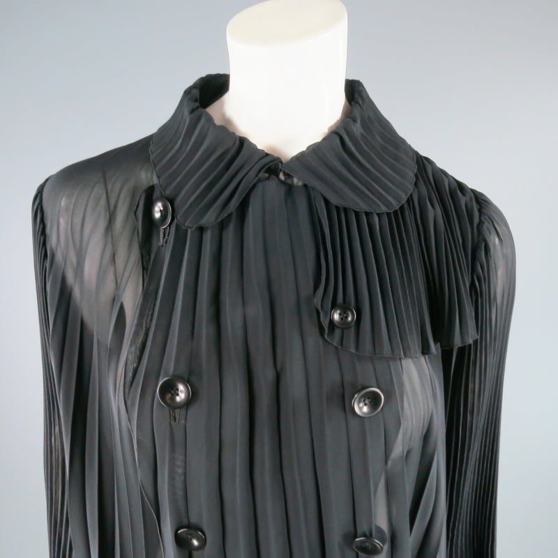 Fabulous avant garde trench coat from UNDERCOVER by Jun Takahashi. A classic style with a twist, this gorgeous piece comes in sheer black accordion pleated chiffon and features a peter pan collar, double breasted button closure, back flap, and