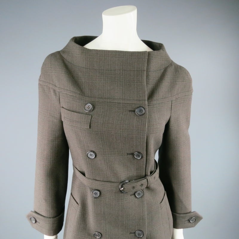 Tailored wool coat by PRADA. In a lovely olive glen plaid, this impeccably structured piece is inspired features a wide neckline, retro silhouette, double breasted closure, buttoned cuff, and matching fabric covered waist belt. Made in Italy.
