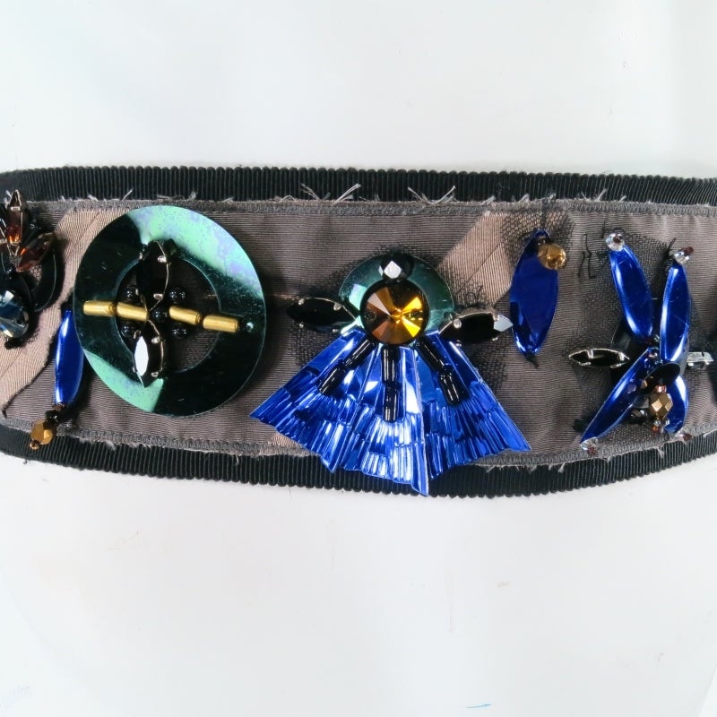 Black ribbon waist belt by PRADA. A gorgeous statement piece with a retro vibe featuring various sequins, mirrors, beads, and crystals, in purple, green, gold, and black over a layer of tulle and taupe silk. Tie it over any piece to add some
