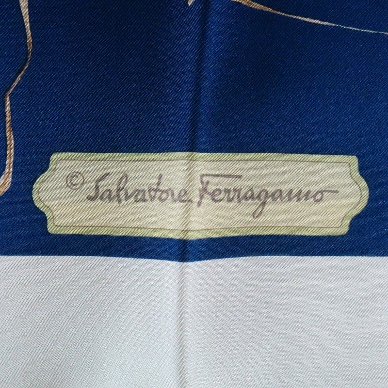 Gorgeous navy scarf by SALVATORE FERRAGAMO. A large square style with cream boarder and navy background featuring tropical blue and white flowers with leaves and tied ropes. Made in Italy.
 
Brand New with Box.
 
35 x 35 in. (90cm)