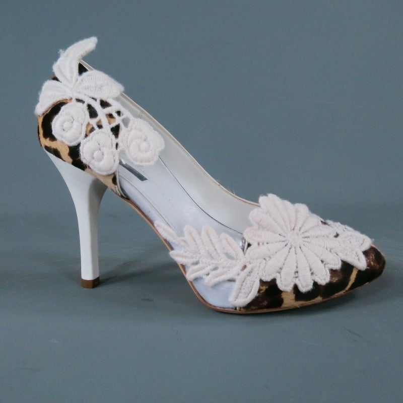 Fabulous platform pumps by DOLCE & GABBANA. Another sexy and unique mixed fabric style, they come in leopard pony hair with a clear vinyl panel and feature large white floral crochet lace embellishments, white leather covered stiletto heel, and