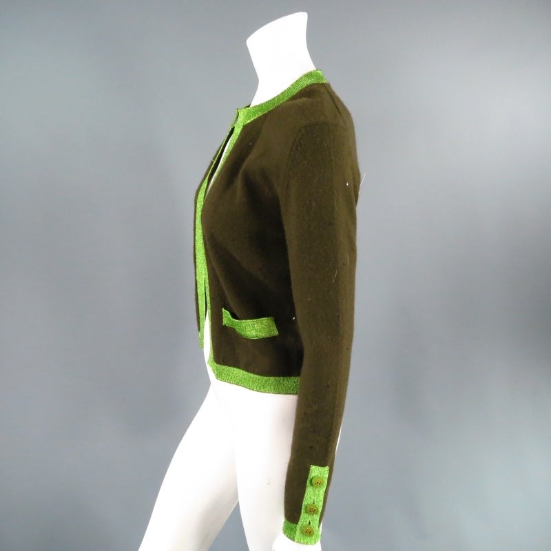 This set includes Cardigan & matching short sleeve Top.

Lovely cashmere cardigan by CHANEL. A fun light weight style in olive cashmere embellished with sequin featuring a crew neck, patch pockets, buttoned closure sleeves with green and gold 