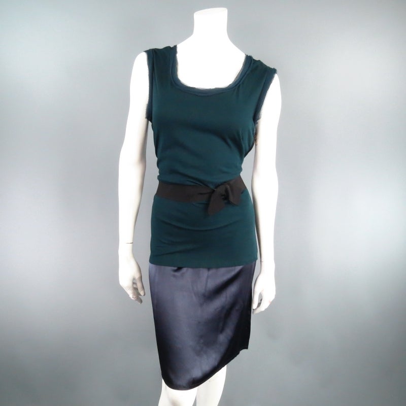 Lovely two tone sheath dress by LANVIN. A fun sleeveless style featuring a teal cotton, raw edge tank top with black ribbon bow belt layered over a navy silk slip dress with exposed side zipper. Original tag included. Made in France.
 
Excellent