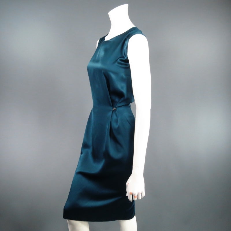 Fabulous sleeveless shift dress by LANVIN. This style comes in a gorgeous jewel tone teal nylon / silk satin and features hook eye embellishment detail that fastens to create darts along the waist line and cinch it in. Define the waist or wear it