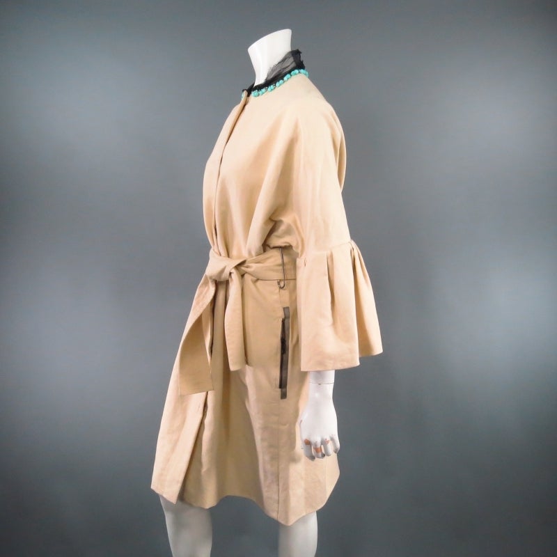 Fabulous beige cotton trench coat by LANVIN. This ultra chic style features a high neckline embellished with a raw black tulle collar with teal beading and green crystals, gorgeous pleated ruffle 3/4 flounce sleeves, hidden placket snap closures,