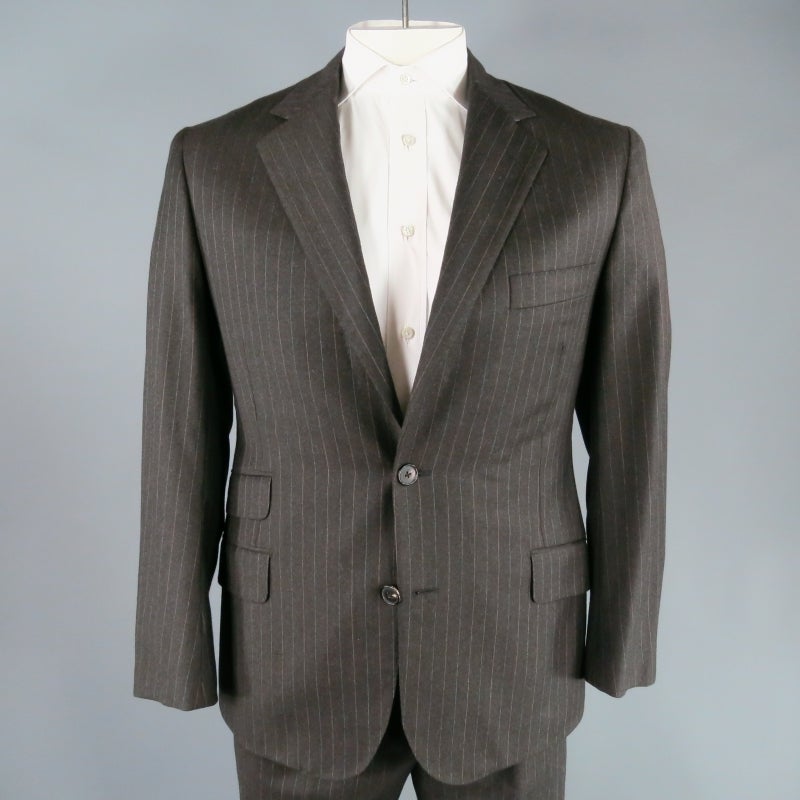 Classic fall gauge wool suit by Hermes in dark charcoal with alternating red and blue pinstripe detail.  This updated take on a timeless look comes in a medium gauge, dark charcoal wool fabric.  This suit is can go from morning to night and can be