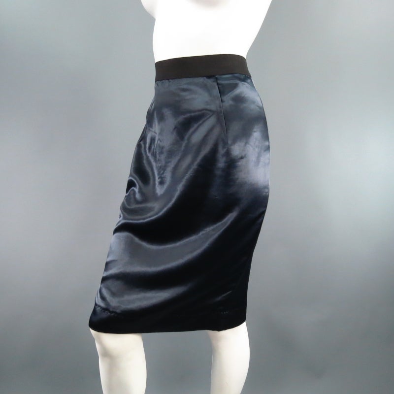Lovely navy pencil skirt by LANVIN. A classic staple redesigned, this piece comes in gorgeous semi structured silk/Cupro satin and features folded exterior darts, thick black elastic waist band and exposed back zip slit. Circa 2006. Made in
