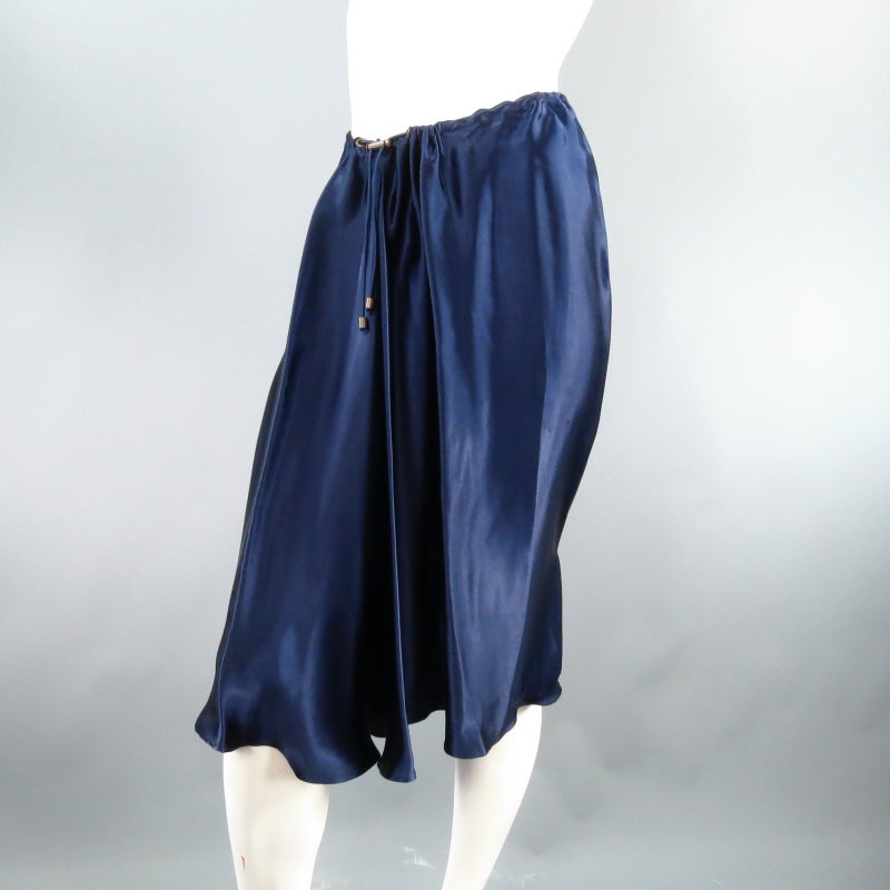 Fabulous gathered dress skirt by LANVIN. A unique style with a blousey fit, this piece comes in a gorgeous jewel tone navy satin and features a gathered waist with elastic chord that adjusts through grommets on the front as an embellishment. There