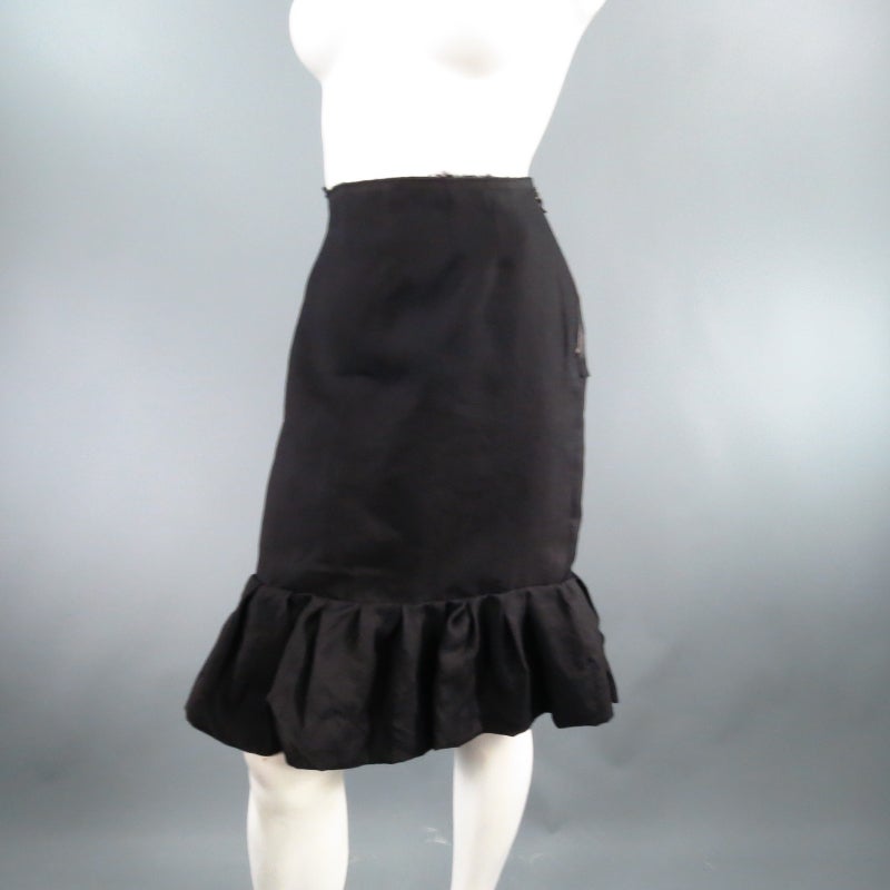 Lovely black silk pencil skirt by LANVIN. This style comes in a semi matte textured fabric and features a raw edge waist line with darts and pleated ruffle hem. Circa 2006. Made in France.
 
Excellent Pre-Owned Condition.	Tag Size: 38	Fits Like: