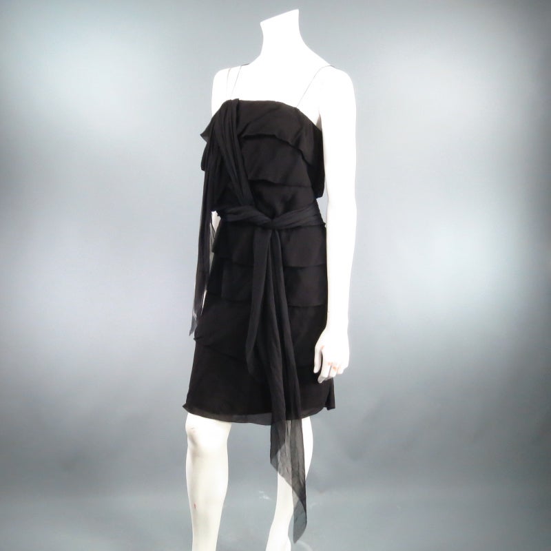 Gorgeous black silk cocktail dress by LANVIN. A fabulous tube style constructed on tiered ruffles in chiffon featuring skinny straps, and a long raw column that drapes from the bust line you can tie around the waist or drape over your shoulder.