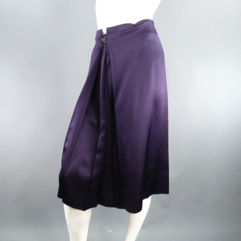 Fabulous A-line skirt LANVIN. This piece comes in a gorgeous, flowing eggplant silk satin and features symmetrical  layered front pleats that fold inward and fasten with a charcoal clasp. Circa 2007. Made in France.
 
Excellent Pre-Owned