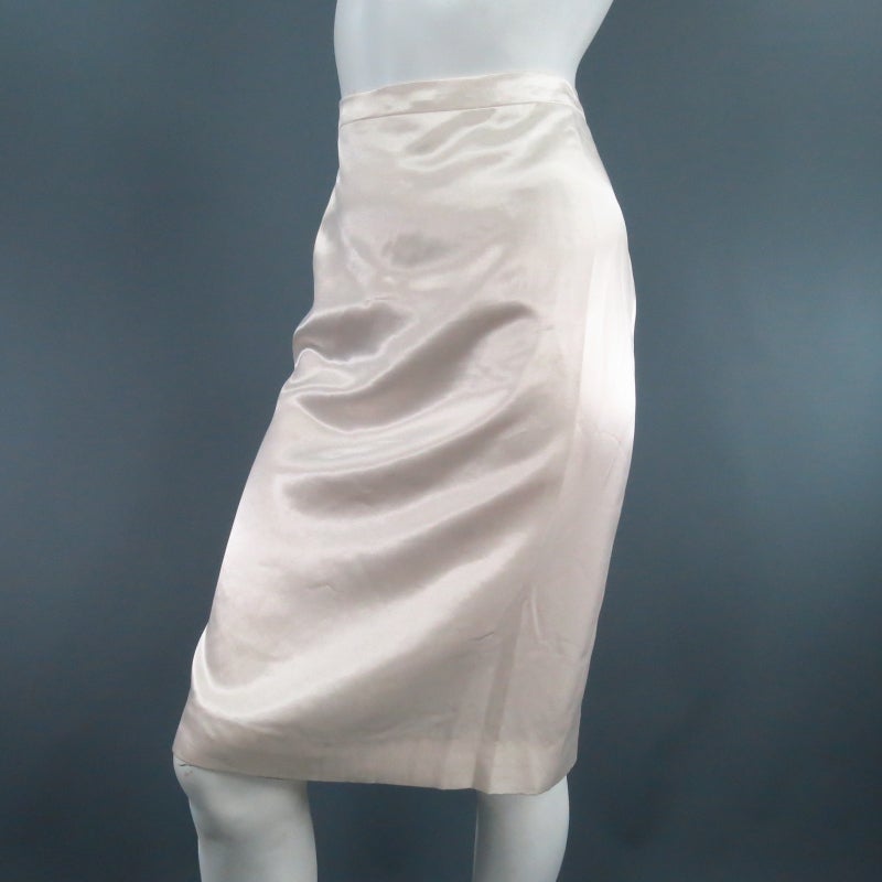 Lovely cream silk blend pencil skirt. A classic style in glossy satin featuring a thin waist band, back slit. and hidden zip and button closure. Circa 2006. Made in France.
 
Excellent Pre-Owned Condition. Tag Size: 40	Fits Like: US 8
 
Waist: