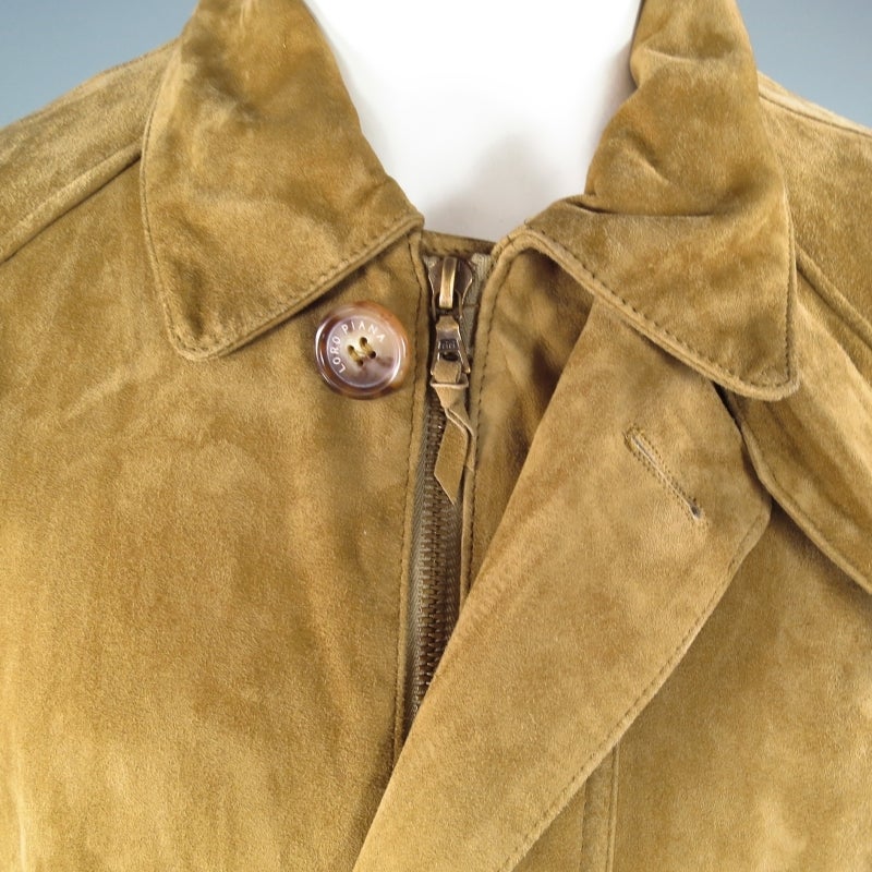 LORO PIANA Jacket consists 100% suede material in a tan color tone.
Designed with a front button/zipper closure, drawstring cinch at internal waist, 2 front flap pockets with button closure. Tone-on-tone stitching can be seen throughout shoulders