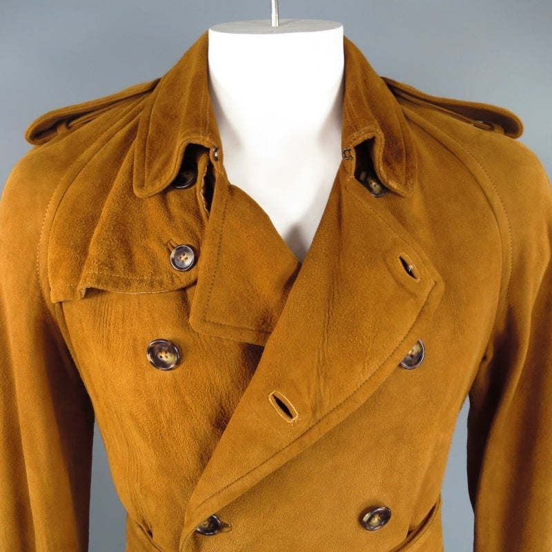 MICHAEL KORS Trenchcoat consists of 100% suede material in a vibrant tan color tone. Designed with a double breast front featuring brown buttons, notch lapel collar, tone-on-tone stitching throughout body with belted cuff sleeves. Includes 2 front