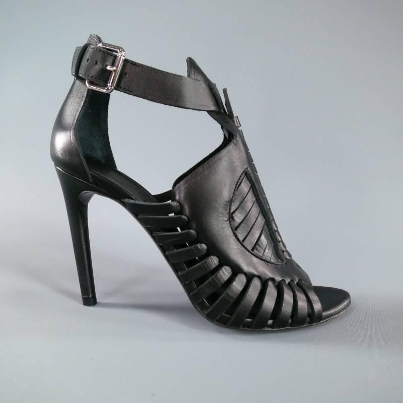 Ultra chic high heeled runway sandals by Proenza Schouler. This sleek style comes in structured black leather and features a gorgeous woven detailed front with peep toe, straight heel, and ankle buckle. Made in Italy.
 
Brand New w/Box.
 
Heel: 4 in.