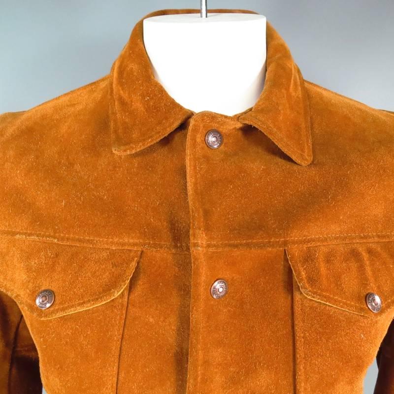 Vintage trucker jacket by SCHOTT. This iconic American classic comes in a rich tan textured suede and features a classic denim trucker jacket cut with double breast flap pockets, slit pockets, pointed collar, and copper tone 