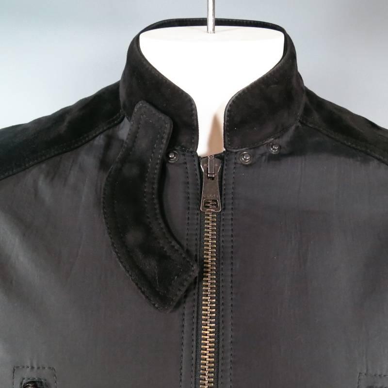 Ultra chic cropped biker jacket by GUCCI. This unique style comes in black nylon and features black suede panels on the shoulder and sleeve, stand up collar with snap neck tab detail, structured waist pad band detail, and symmetrical zipper pocket