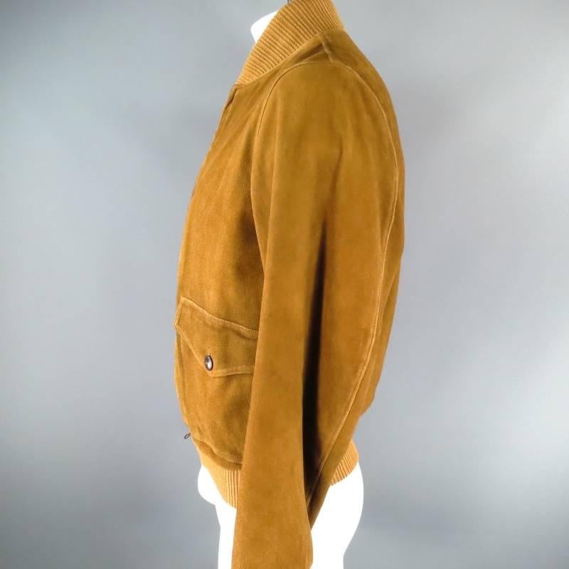 This great fall Suede Jacket from RRL by Ralph Lauren is designed in a bomber style with tone-on-tone stitching seen throughout the body of the jacket.
The Suede jacket also features front flap pockets, button closure and zipper front opening, the