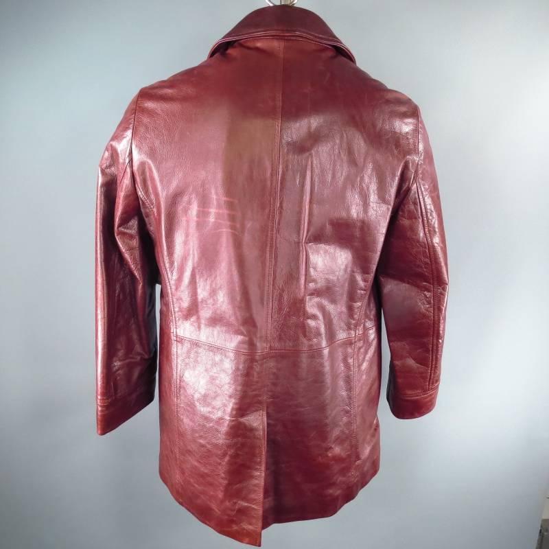 Dolce and Gabbana Jacket consists of leather material in  a burgundy color tone. Designed in a double breasted style, notch lapel collar and tone-on-tone stitching can be see throughout edging of jacket. Includes multi front pocket with a flap