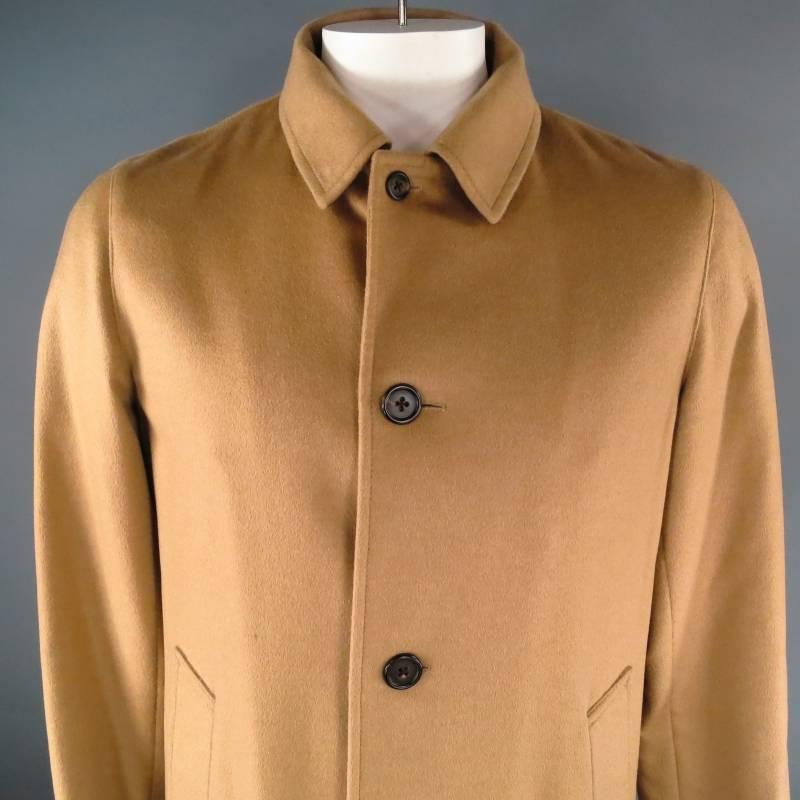 Marc Jacobs Coat consists of camel hair material in a light tan color tone. Designed in a long coat style, 4-button front, notch lapel collar with tone-on-tone stitching and double button cuff sleeve. Includes inside side pockets and single back