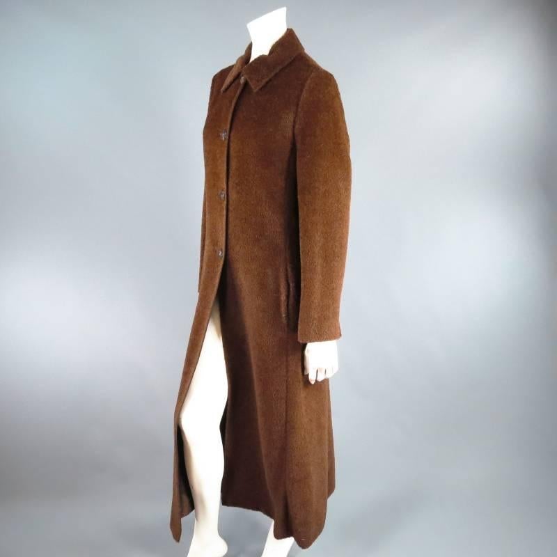 Fabulous reversible winter coat by MAX MARA. This classic style comes in a fuzzy textured alpaca / wool blend and features a minimal design with pointed collar, slit pockets, and tortoise button closure and can be worn reversed in a beautiful