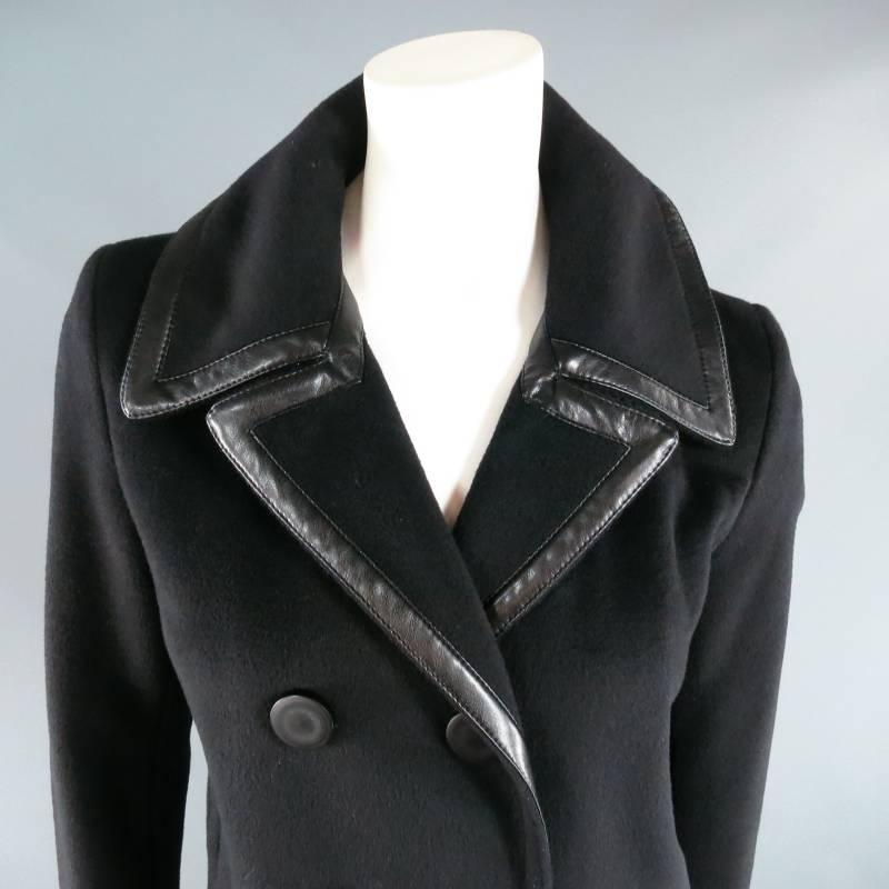 Fabulous black pea coat by BALENCIAGA. A chic classic style from the Nicolas Ghesquiere era in black virgin wool blend, featuring a button closure, slit sleeves, side slit pockets, and leather piping on the collar. Made in Italy.
 
Excellent