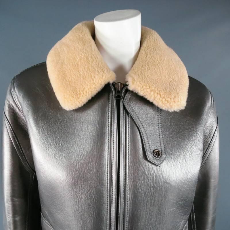 Fabulous RLX by RALPH LAUREN winter jacket. This rare and unique piece comes in a gorgeous metallic silver lambskin leather and features a cream shearling collar, zip closure, frontal pack snap pockets, collar tab, and side tabs. A bold sporty