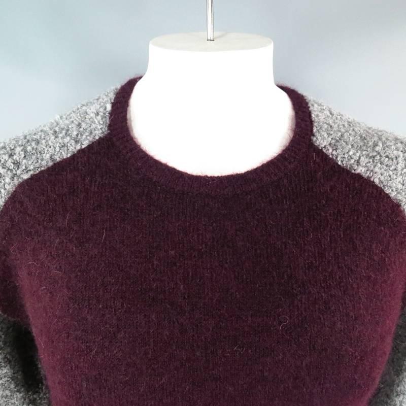 Two tone pullover sweater by NEIL BARRETT. This modern color block style comes in a deep plum burgundy knit and features a crew neck, skinny fit, an grey textured raglan sleeves. A classic style with high impact.
 
Brand New with Tags.
 
Chest: