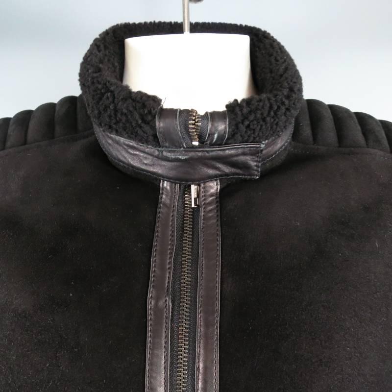 Ultra chic winter coat by TOM FORD at GUCCI. This rare archive piece comes in a sleek suede shearling and features a unique strap and snap collar with leather trim, zip closure, frontal pockets, padded motorcycle ribbed detail on shoulder and